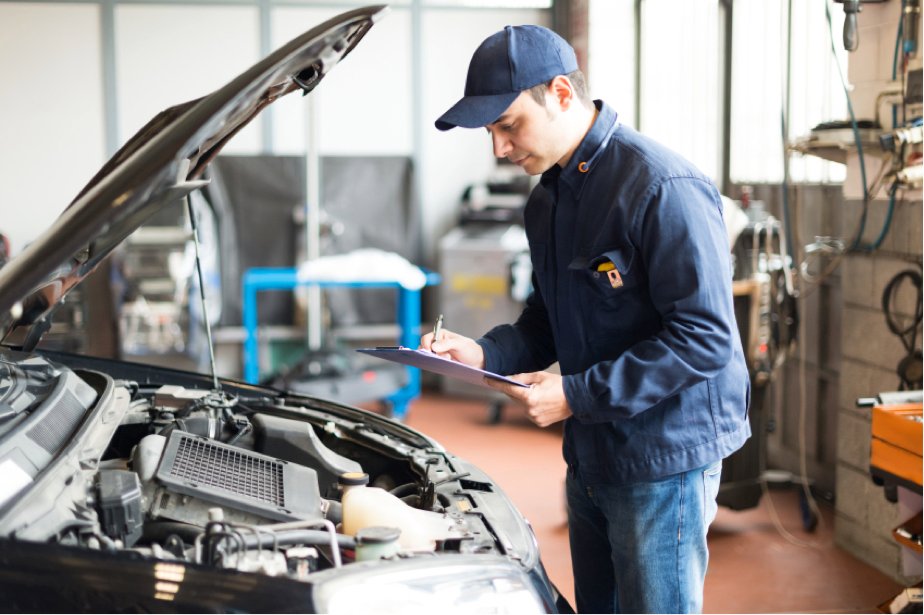 Mechanic checking the engine of a car